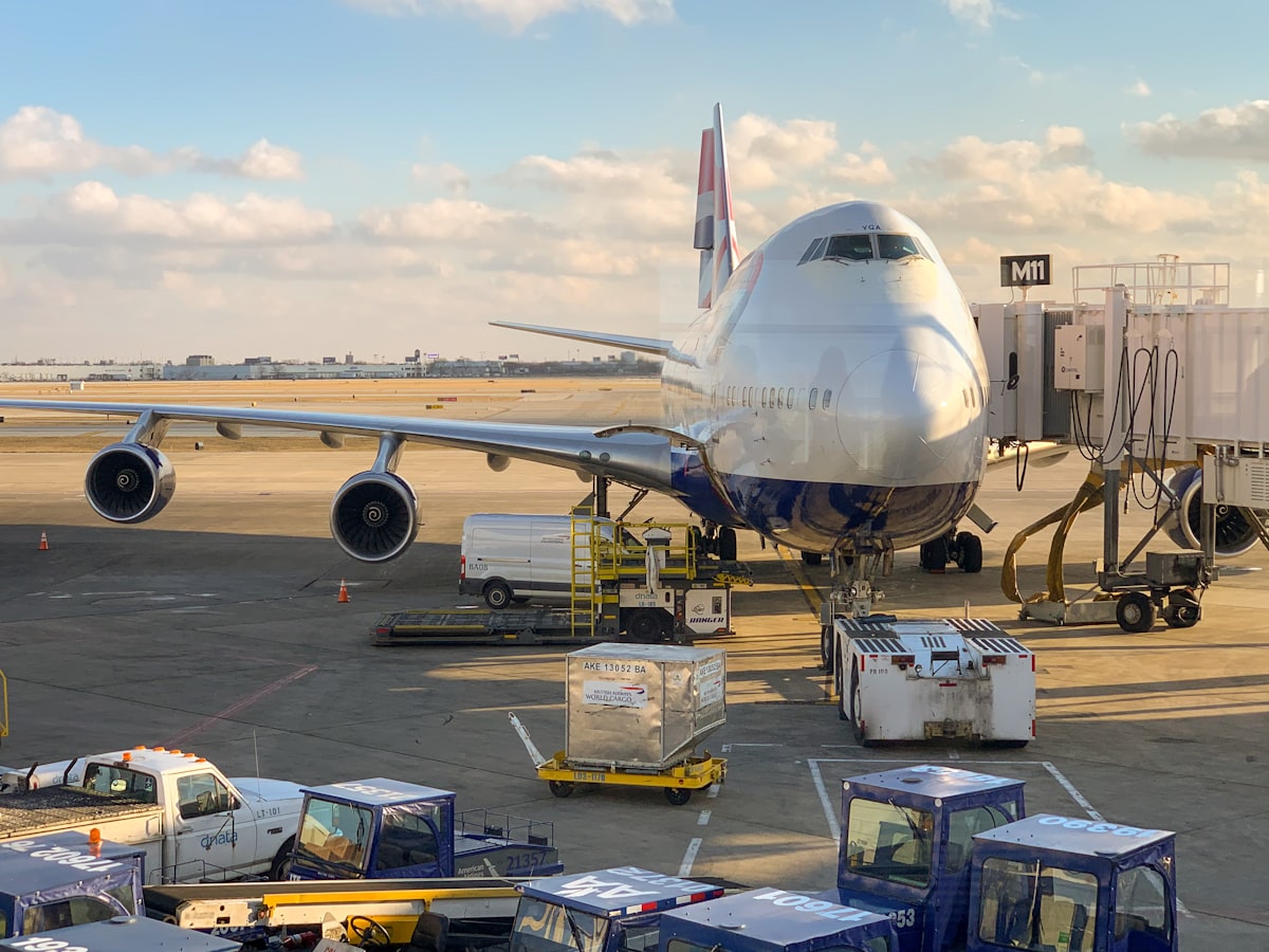 A commercial airliner on an airport tarmac at golden hour